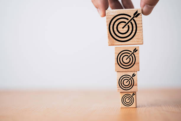 istock Han putting the biggest target board on wooden block for enhance business objective target concept. 1359817831