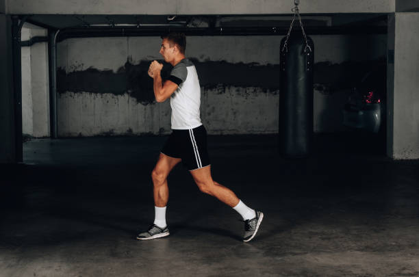 istock Young man boxing workout in an old garage 1359818545