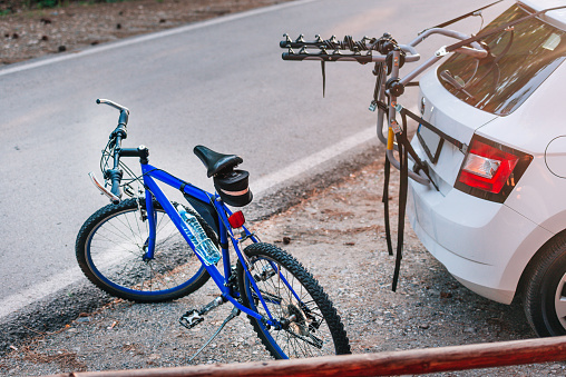 Comparison between a bike and a car eco drive and petrol drive. Parked bicycle and car on an empty road.