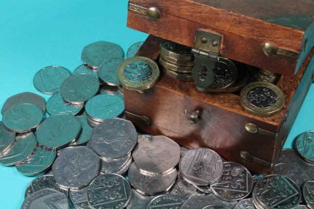 istock Box with British Pound Coins Spilling Out 1359819430