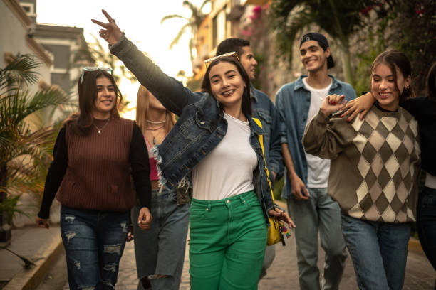 teenager friends walking and dancing outdoors - mexican ethnicity imagens e fotografias de stock