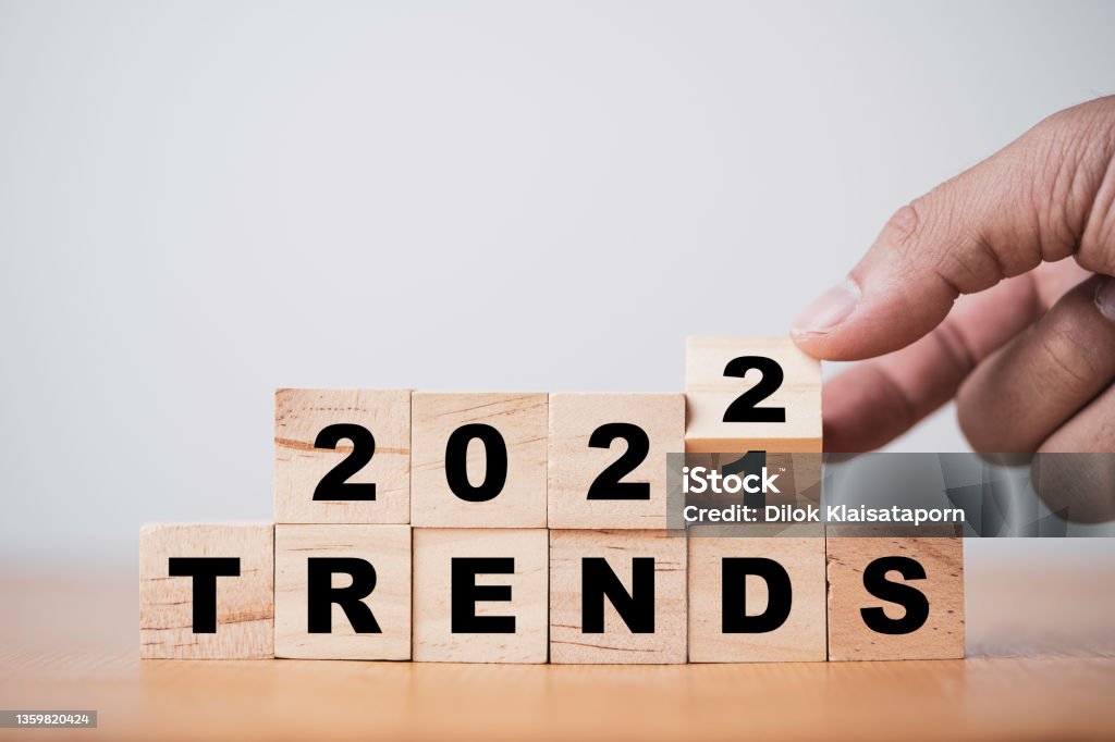 Hand flipping wooden cube block for change 2021 to 2022 trend concept. Youth Culture Stock Photo