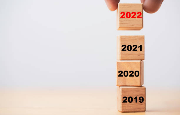 istock Hand putting and stacking 2022 which print screen on wooden cube block for preparation merry Christmas and happy new year concept. 1359820570