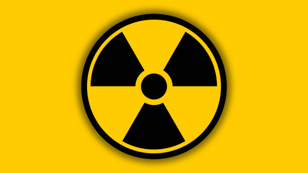 Nuclear radiation warning sign. Nuclear radiation warning sign on a yellow background with blur black circle. nuclear symbol stock illustrations