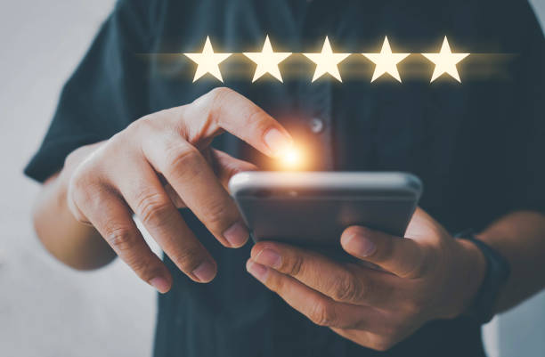 istock Customer review satisfaction feedback survey using smart phone and give five star symbol to increase rating of company concept, Customer service experience and business satisfaction survey. 1359820678