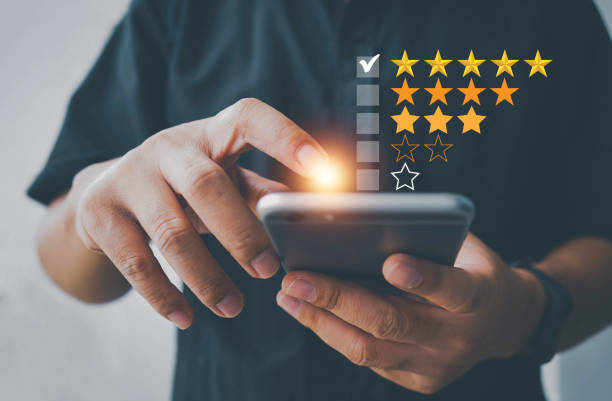 Customer review satisfaction feedback survey using smart phone and give five star symbol to increase rating of company concept, Customer service experience and business satisfaction survey.