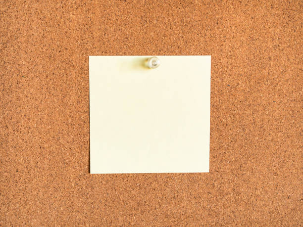 istock yellow blank note paper pinned to corkboard 1359820843
