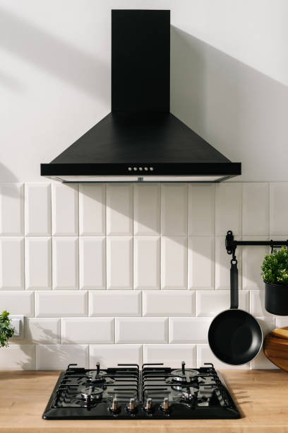 コンロ、パン、抽出器が付いた居心地の良いキッチンインテリアデザイン - range hood ストックフォトと画像