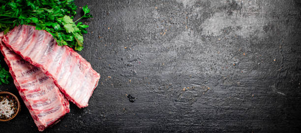 istock Raw ribs with herbs and spices. 1359823237