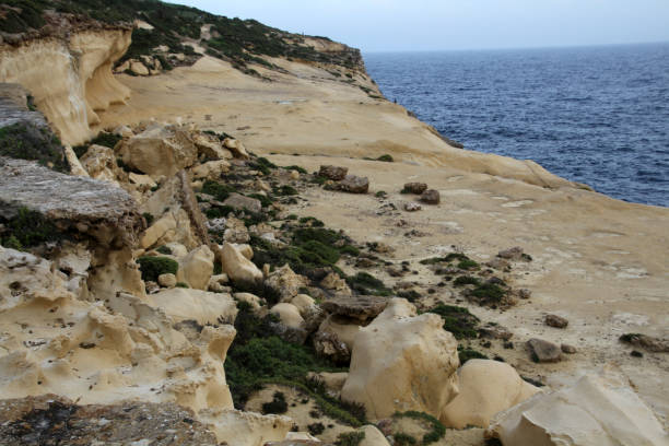 istock Eroded sandstone cliffs of Xlendi, Gozo, Malta 1359826334