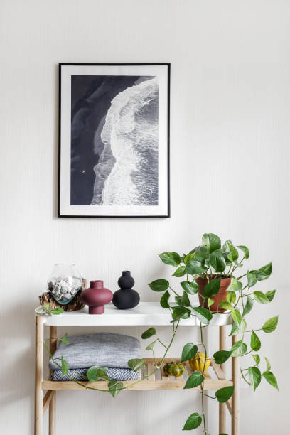 istock Picture frame with ocean view hanging on wall over home decor 1359826618