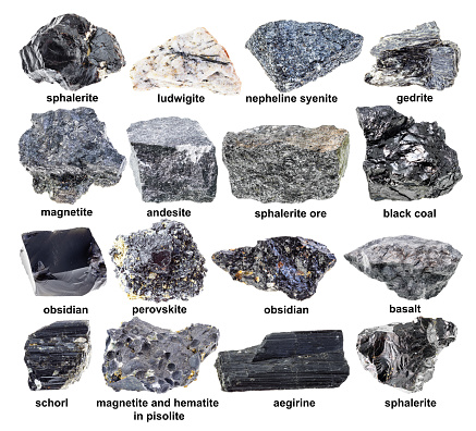 set of various unpolished black minerals with names cutout on white background