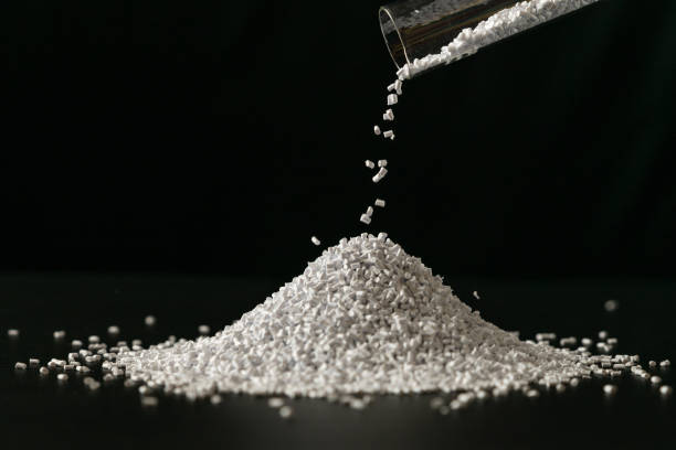 istock White plastic beads on wood  background, Polymers bead or polymer resin, polymer pallet, Product from petrochemical plants. granules polymer, 1359826887