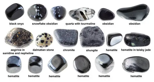 set of various tumbled black stones with names cutout on white background