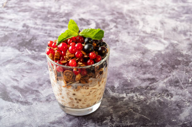 istock A glass with different currants on the table. Fresh currants and mint leaves. View from above. 1359828819