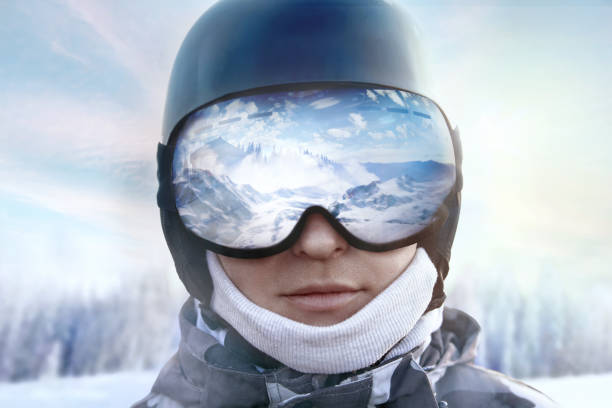 A mountain range reflected in the ski mask. Winter Sports.Wearing ski glasses. stock photo