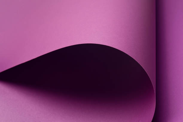 istock Violet curved shapes forming bold abstract background. 1359830253