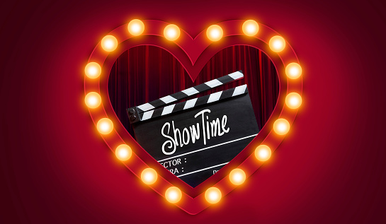 Showtime.Handwriting on film slate.storytelling inspiration Screenwriting and Filmmaking for Love story in valentine's day.Broadway theatre, show performance in the background.