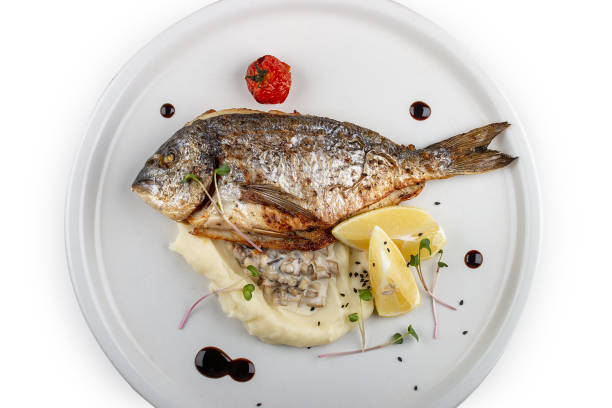 istock Dorado with mashed potatoes and creamy mushroom sauce. Isolated on a white background. 1359830468