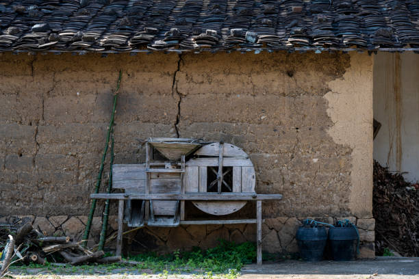The paddy windmill in the countryside, the farm implements by the mud wall