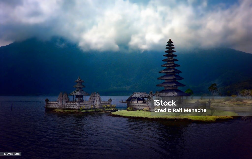 The nineties. Hindu Temple - Pura Ulun Danu Bratan . Bali, Indonesia. Java, Indonesia, September 1991. Pura Ulun Danu Bratan, the Hindu temple after a heavy thunderstorm..
Please note that the image was scanned from an over thirty years old negative. Bali Stock Photo