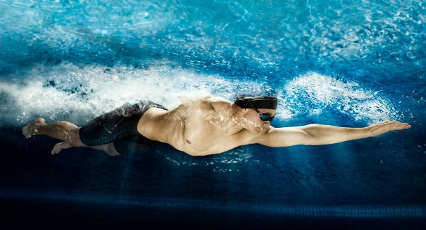istock Professional man in swimming pool.  Underwater 1359831753
