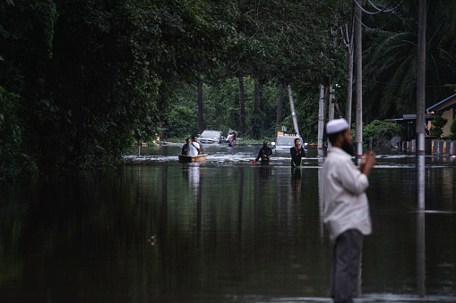 Shah Alam, Malaysia-December 19, 2021: A scene where cars stranded and rescue mission in a badly affected area during a big flood that happened in a very unexpected area in Shah Alam and Klang.