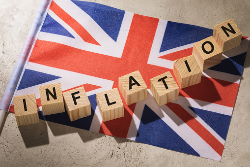 Britain flag and wooden cubes with text, concept on the theme of inflation in england