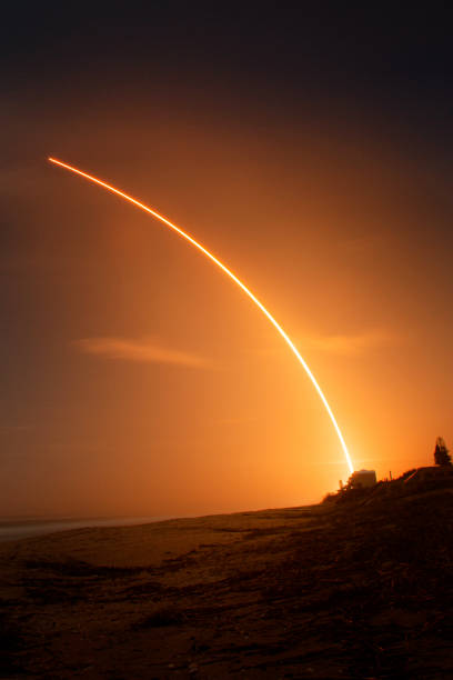 istock Long Exposure Space X Falcon 9 Rocket Launch from Beach Portrait at Night 1359834663