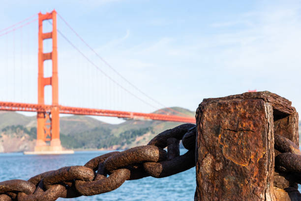 istock Old rusted chain in front of Golden Gate bridge 1359835082