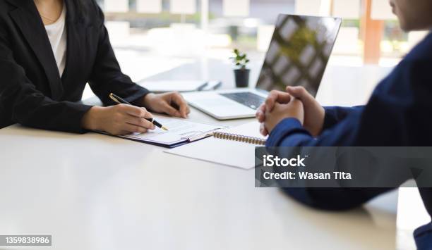 The Manager Is Reading The Resume And Is Interviewing The New Employee Negotiating Business And Signing A Contract Lawyer And Legal Advisor Stock Photo - Download Image Now