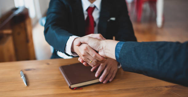 istock Handshake. Business people in the office shake hands greeting congratulations mutual agreement. 1359839004
