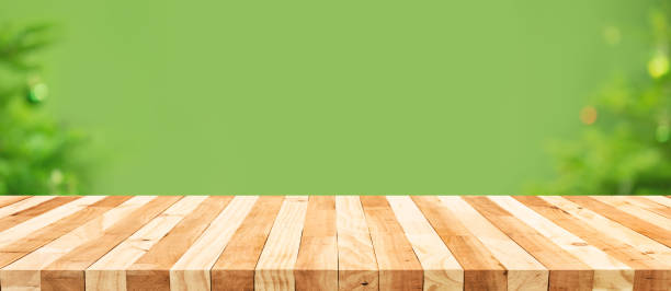 istock Selective focus.Empty wood table top with blur abstract light bokeh of christmas tree,decoration background 1359840063