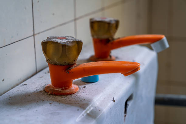 Closeup of an old pastic water tap in a derelict house