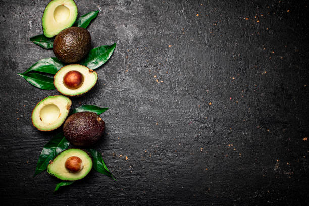 istock Cut ripe avocado with leaves. 1359845048