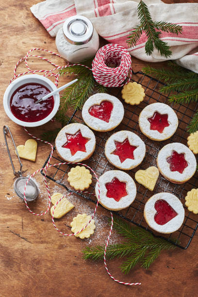 istock Classic Linzer Christmas Cookies with raspberry or strawberry jam on wooden table 1359845079