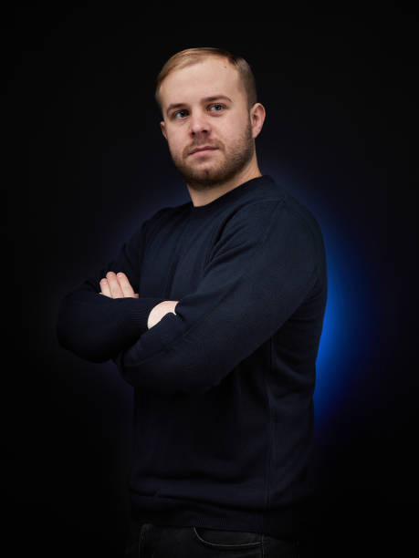 istock vertical portrait  blond man on a dark background, in a jacket 1359846093