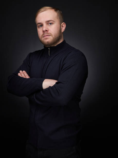 istock vertical portrait  blond man on a dark background, in a jacket 1359846115