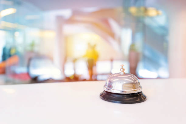 istock Hotel service bell on a table white glass and simulation hotel background 1359847087