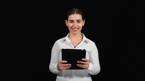 Maintaining corporate connections online. Cropped shot of a smiling businesswoman using a digital tablet black isolated on white.