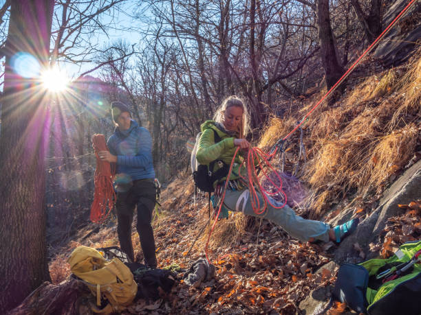 istock Couple rock climbers preparing material and sorting ropes 1359849537