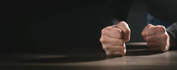 istock Fists of angry man beats on the table. 1359851376