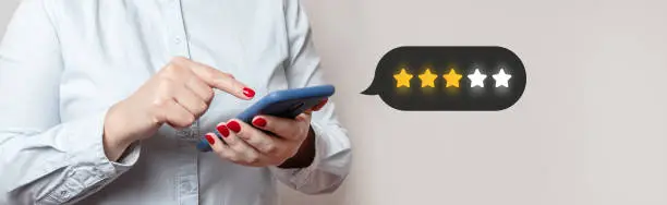 Photo of Customer Experience Concept. Excellent. Person using mobile phone with icon two star symbol to increase rating of company