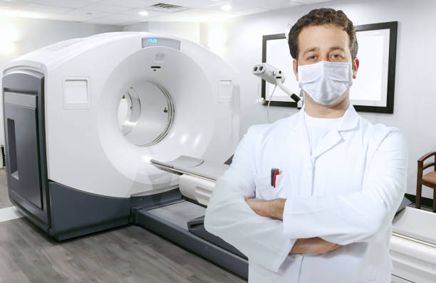 istock Doctor with face mask and CT scan 1359856364