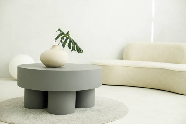 istock A vase with a green leaf stands on a designer table. 1359857012