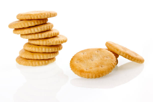 Crackers, salty biscuits, stack of salty snacks on white background. Crackers, salty biscuits, stack of salty snacks on white background. Horizontal photo. Crackers stock pictures, royalty-free photos & images