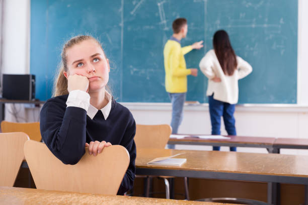 istock Tired student girl sitting in classroom 1359857329