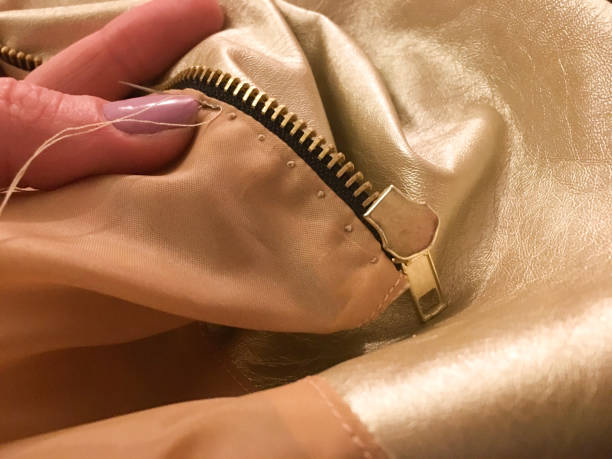 istock Hand Sewing French Knots on Lining Near Zipper 1359858270