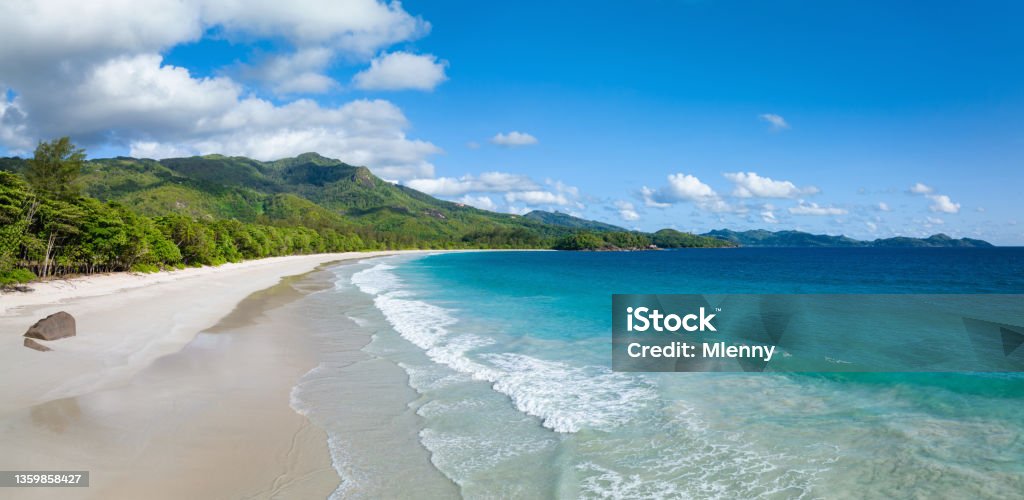 Grand Anse Beach Panorama Mahé Island Seychelles Beautiful Grand Anse Beach Panorama. Empty Beach on Mahé Island under blue summer skyscape. Grand Anse Beach, Mahé Island, Seychelles, East Africa Beach Stock Photo