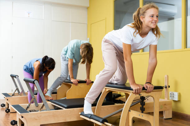 istock Teenagers training pilates in gym with trainer 1359858485